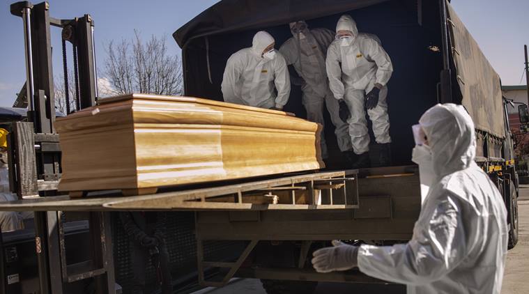 Members of the Italian army and the Carabinieri load the coffins of coronavirus victims onto a truck in Bergamo, Italy, March 24, 2020. Credit to Fabio Bucciarelli-The New York Times